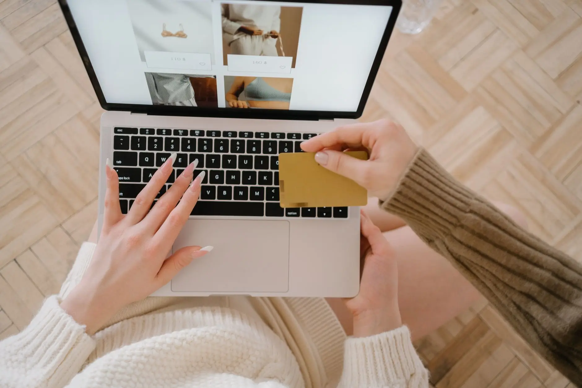 Ecommerce sajt prikazan na laptopu sa dokumentima na stolu