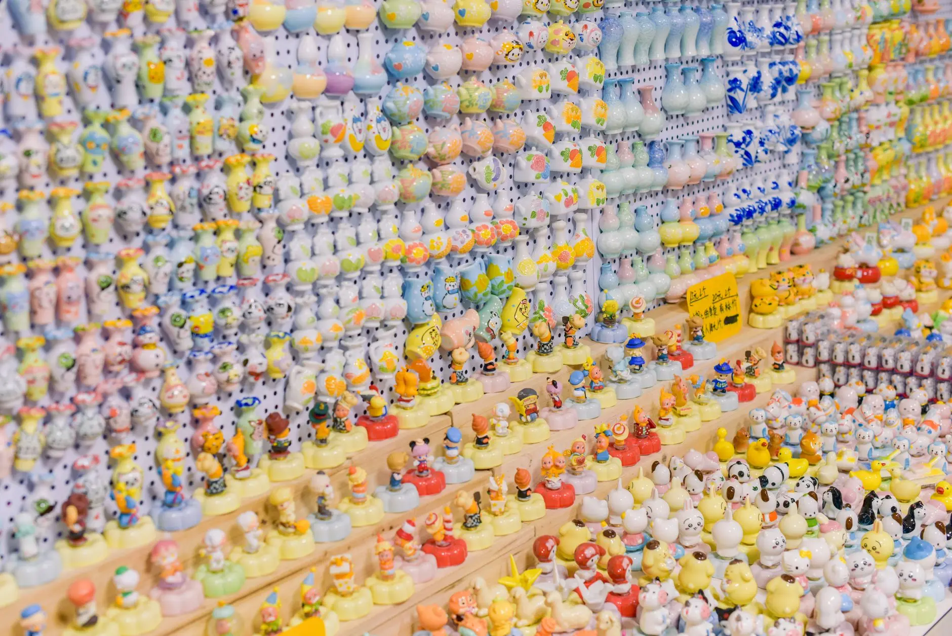 A close-up view of a detailed miniature market scene with tiny shops and stalls on a model landscape.