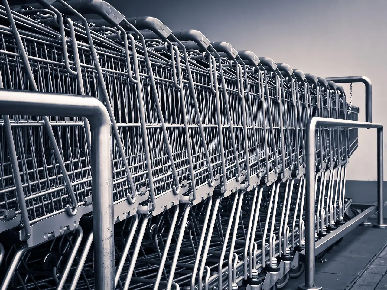 The entrance of a small shop with a window display seen from the street in daylight.